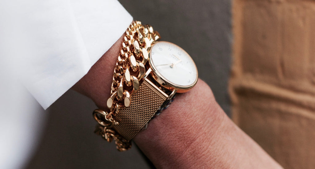 Klocka äldre kvinna guld 33 mm med meshband på kvinnoarm