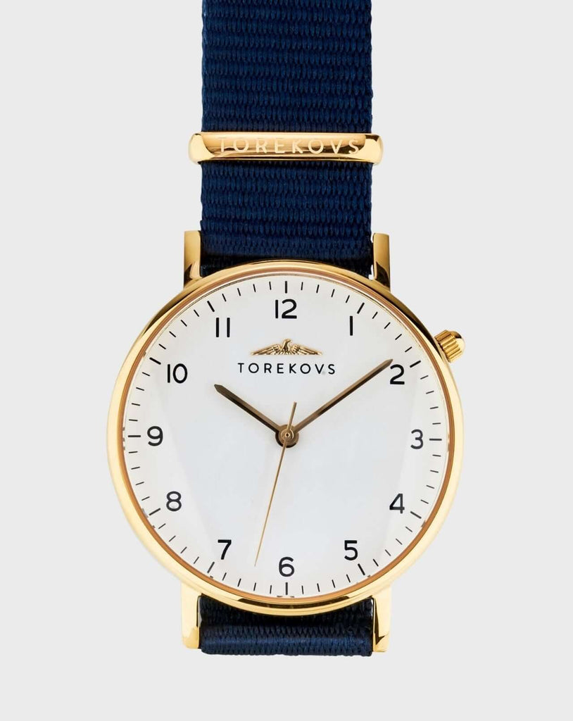 Analog barnklocka och ungdomsklocka i guld med marinblått natoband